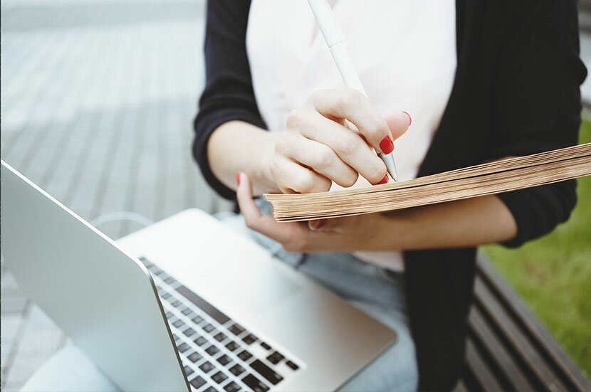 woman writing in notepad